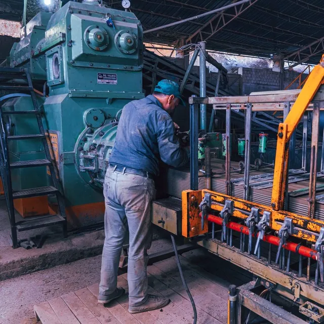 Worker operating machinery in an industrial factory